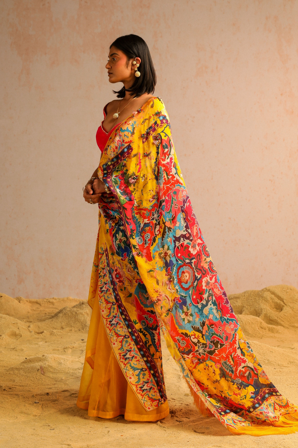 Yellow draped saree with hot pink blouse