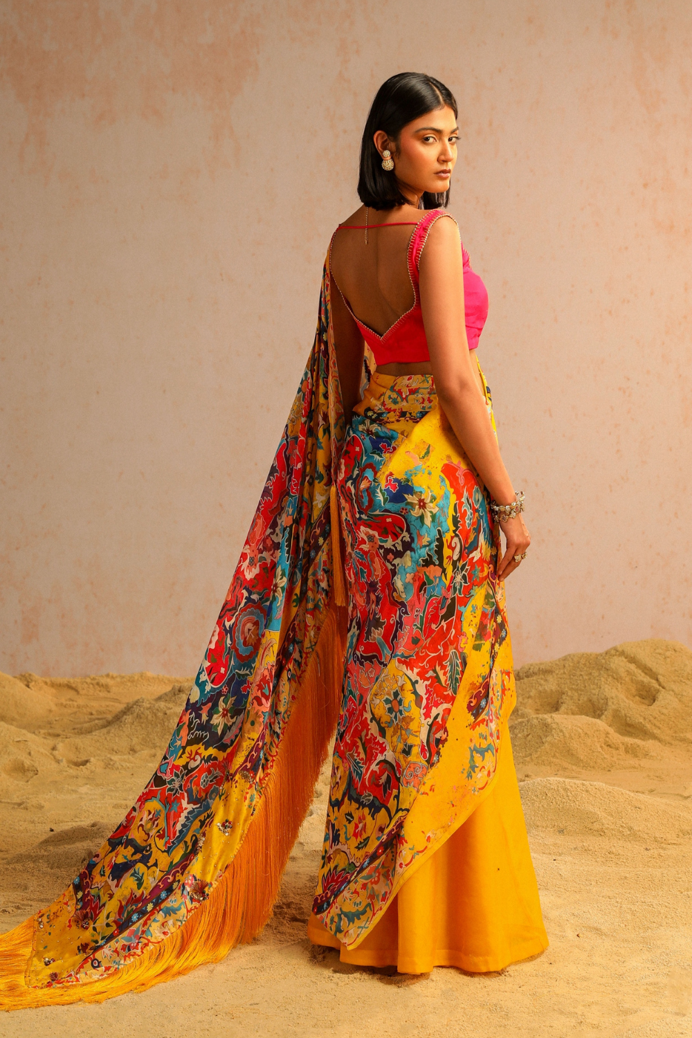 Yellow draped saree with hot pink blouse