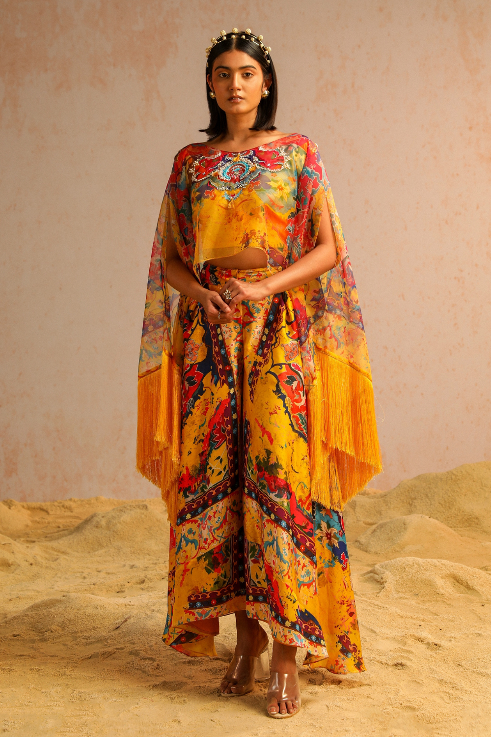 Yellow pants with blouse and cape