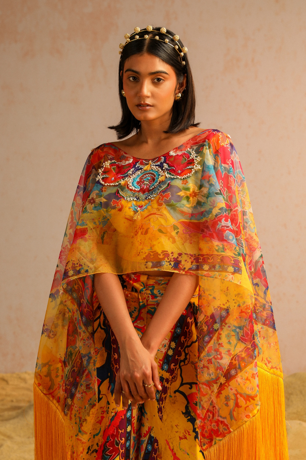 Yellow pants with blouse and cape