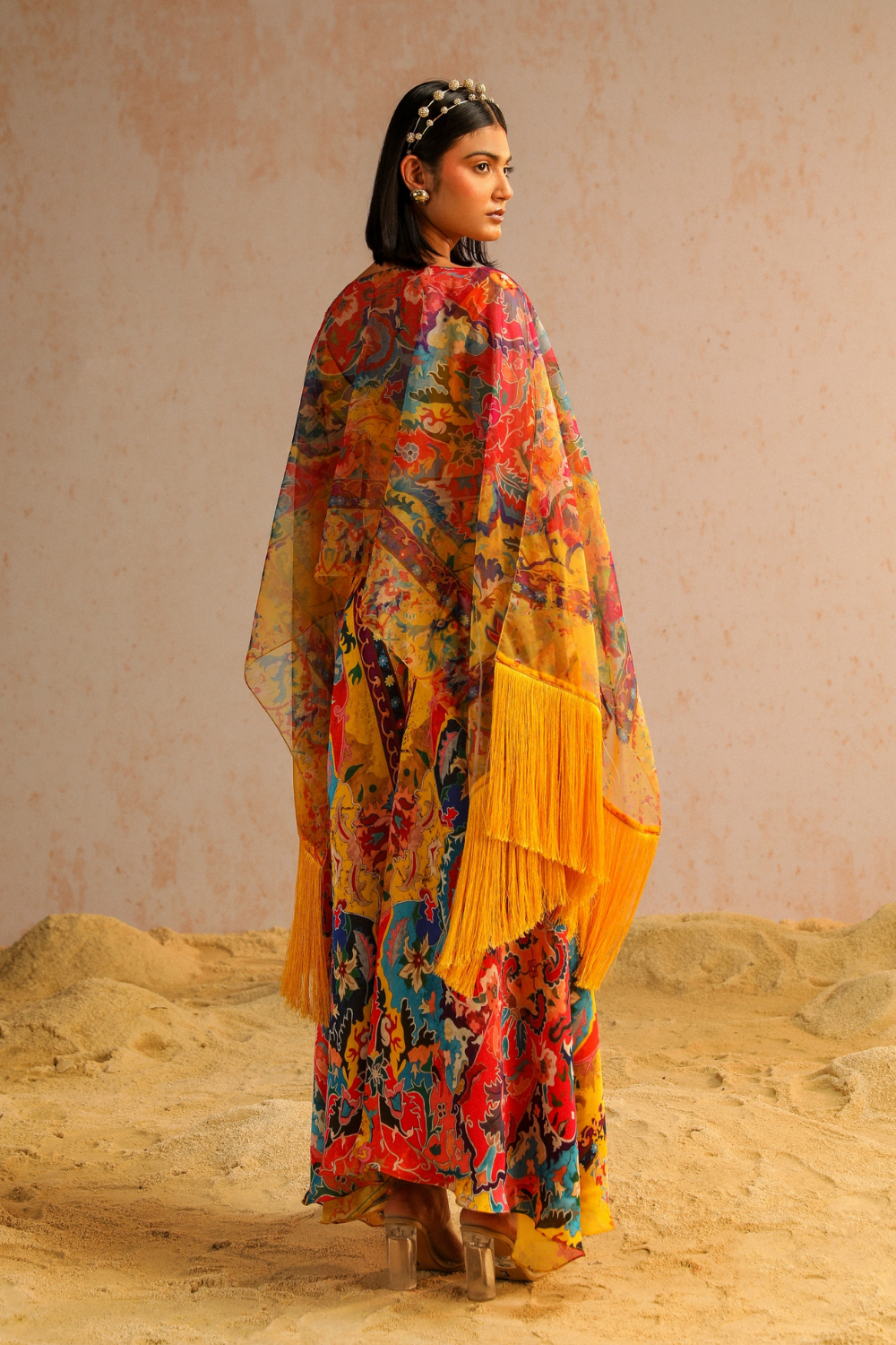 Yellow pants with blouse and cape
