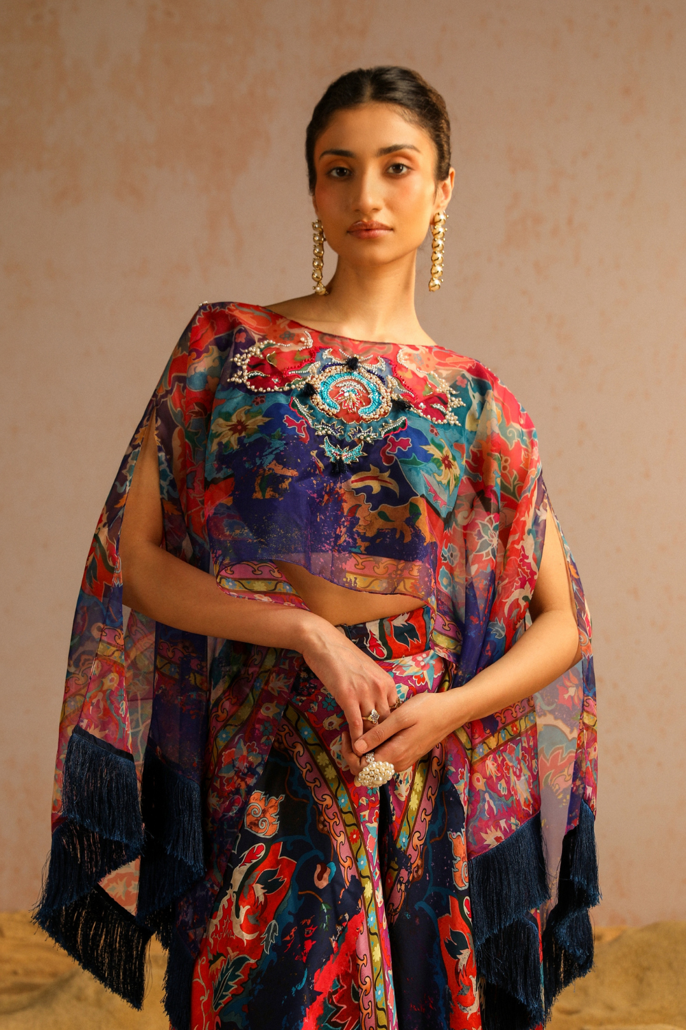 Blue pants with blouse and cape