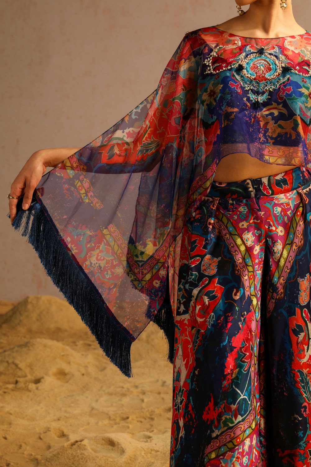 Blue pants with blouse and cape