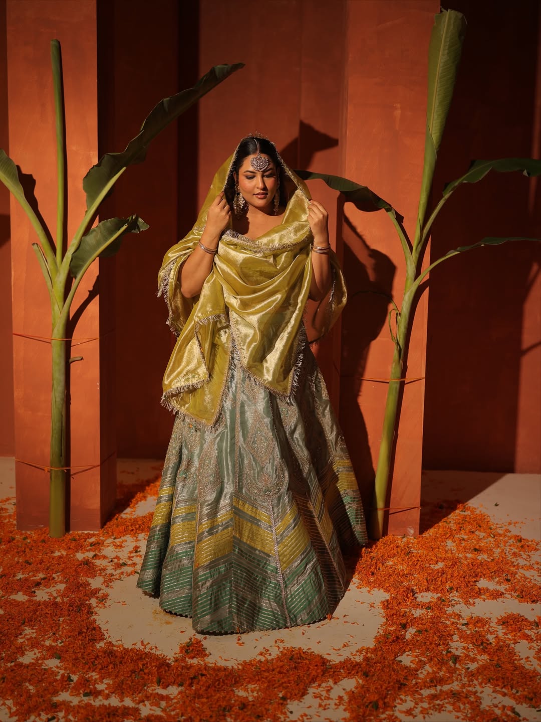 Sakshi Sindhvani in our Ice blue silk zari tissue lehenga with olive bloom dupatta