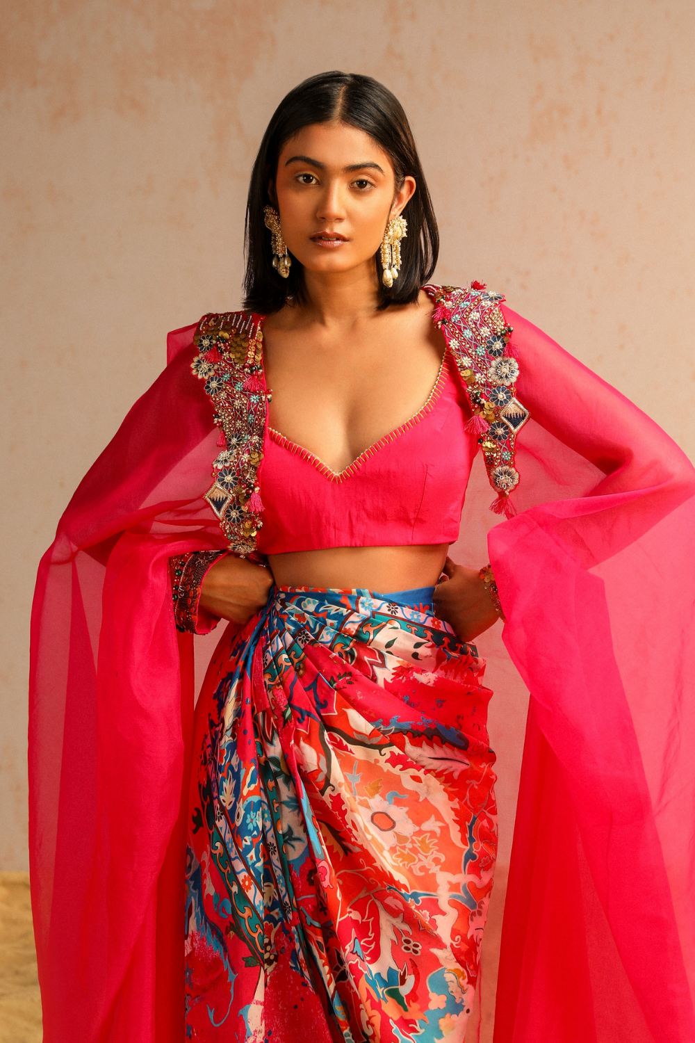 Hot pink draped skirt with blouse and cape