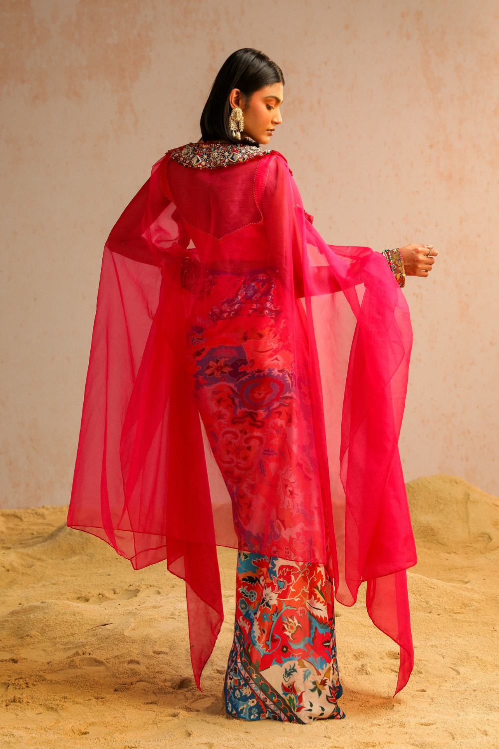 Hot pink draped skirt with blouse and cape