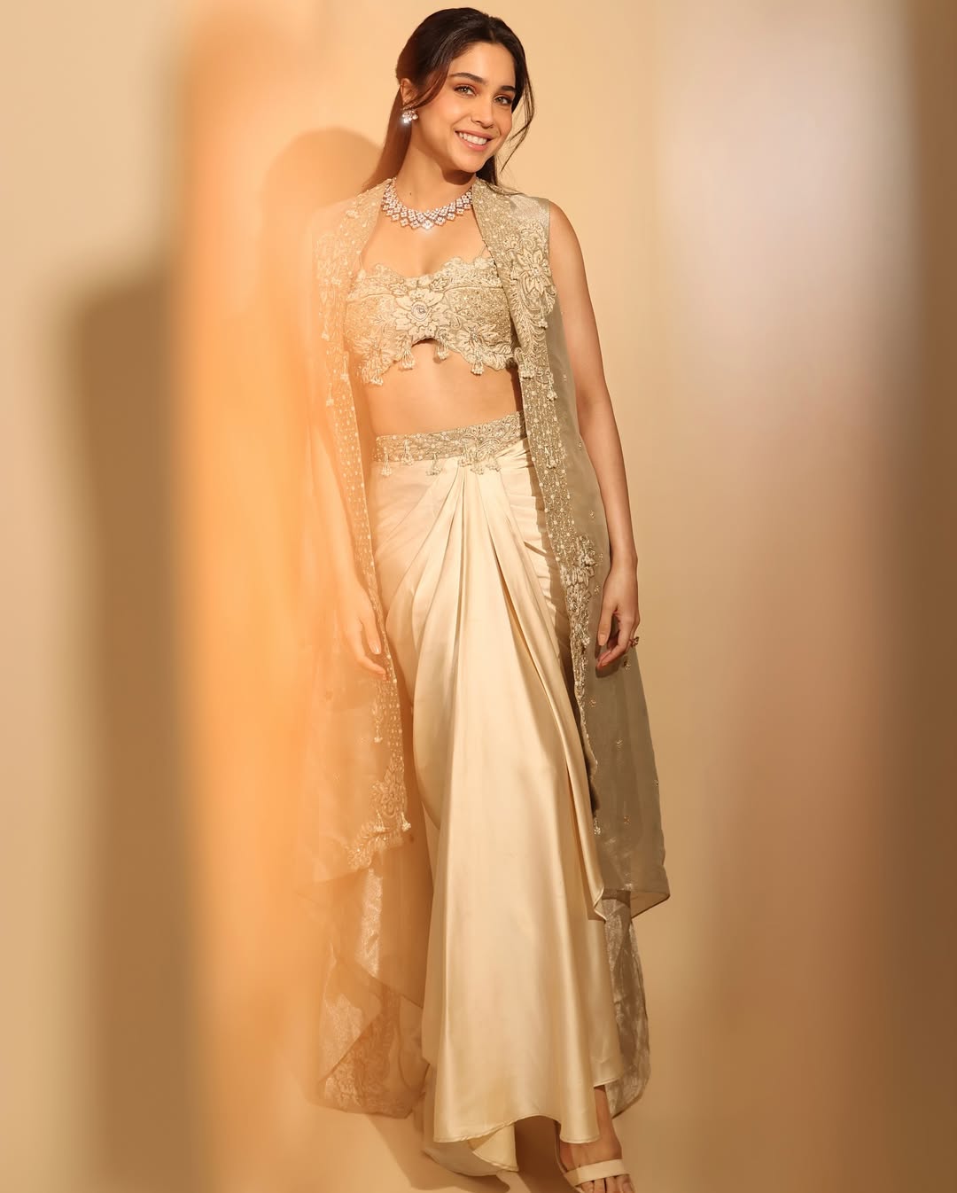Sharvari in our Champagne gold drape satin skirt with cape