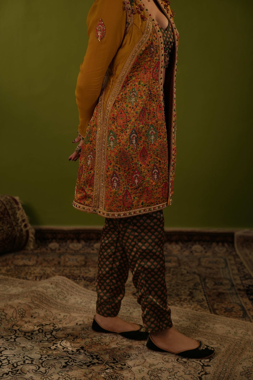 Green pants with blouse and mustard yellow jamawar jacket